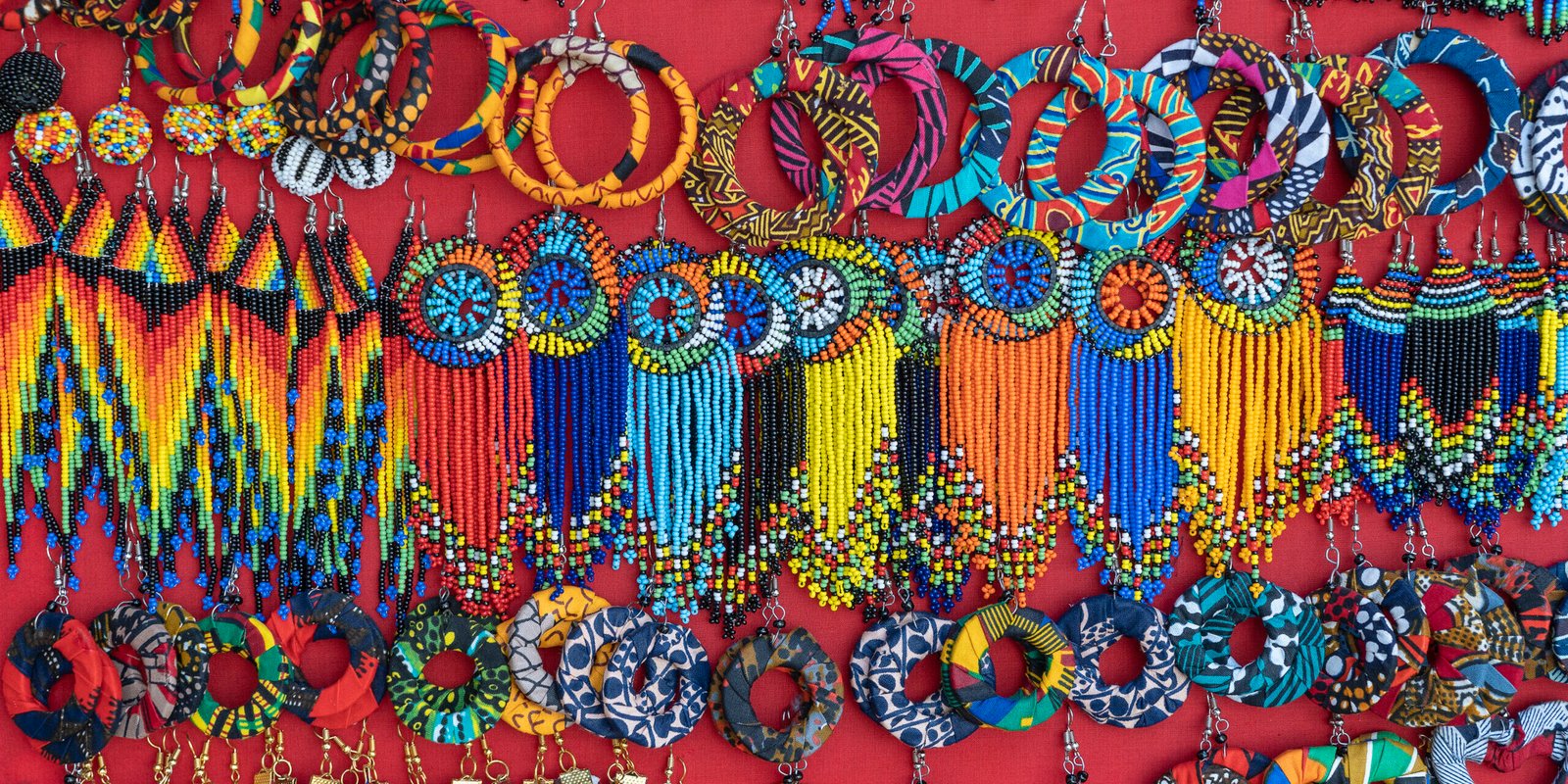Tribal masai colorful earrings for sale for tourists at the beach market, close up. Island of Zanzibar, Tanzania, Africa